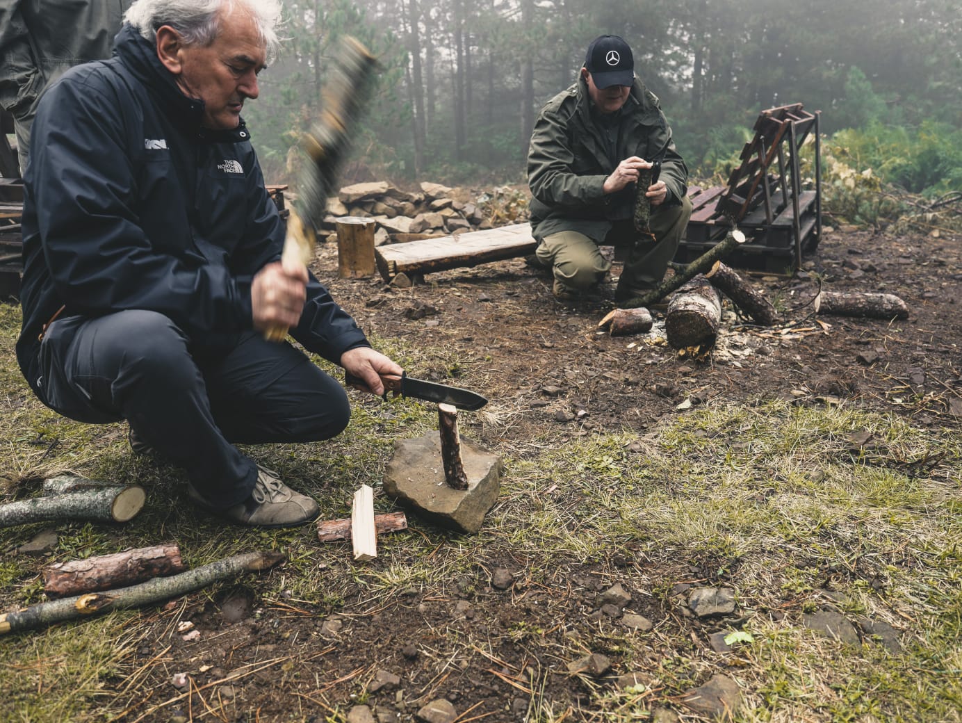 Bushcraft at camp — splitting kindling in the forest