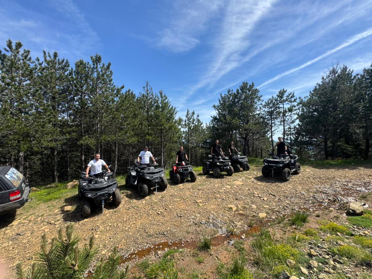 A group of quads on a sunny mountain ridge