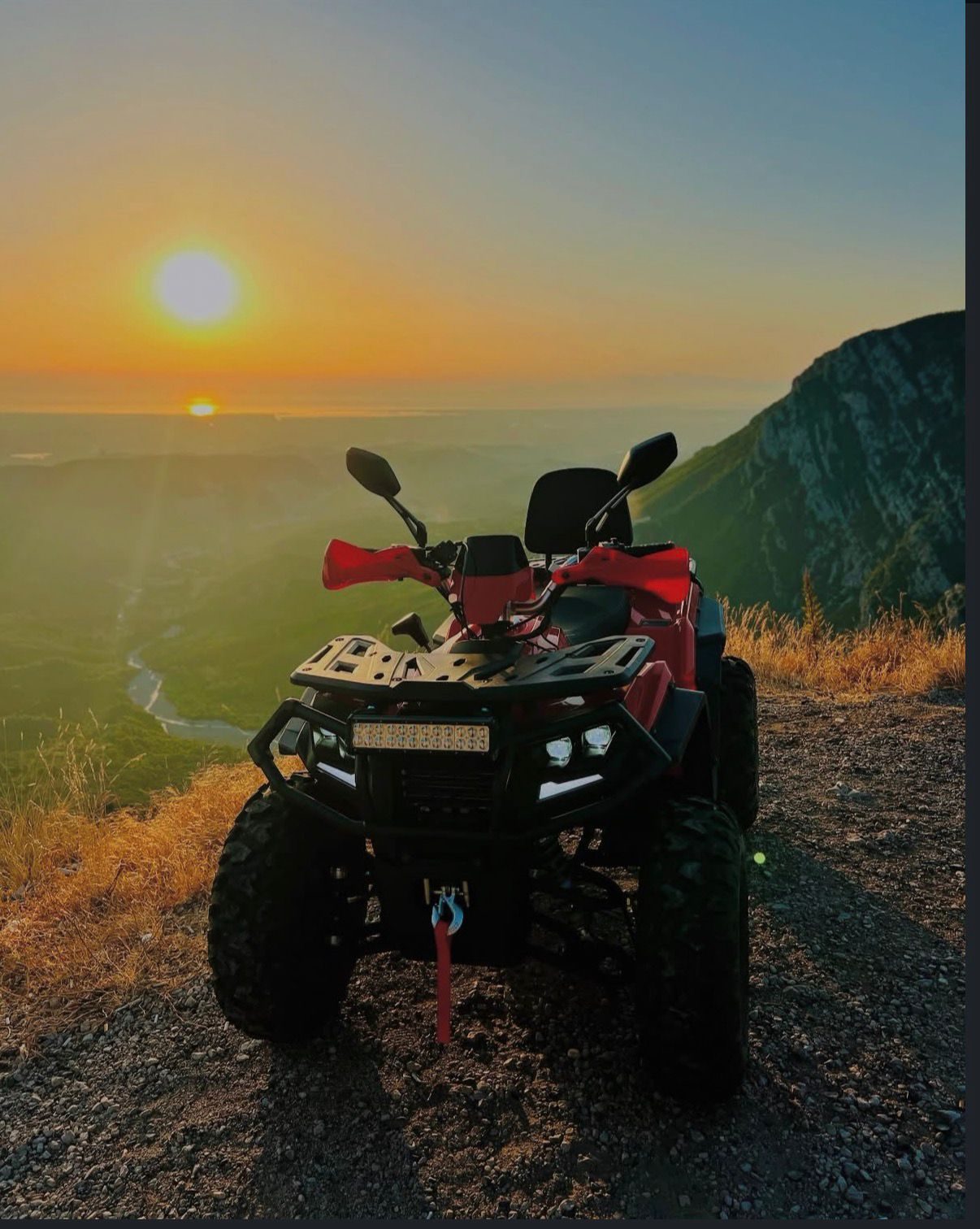 A quad bike at sunset over the valley